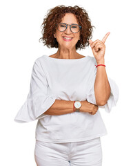 Sticker - Beautiful middle age mature woman wearing casual clothes and glasses with a big smile on face, pointing with hand and finger to the side looking at the camera.