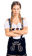 © Krakenimages.com - Beautiful caucasian woman with blonde hair wearing octoberfest traditional clothes skeptic and nervous, disapproving expression on face with crossed arms. negative person.