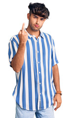 Wall Mural - Young hispanic man wearing casual clothes showing middle finger, impolite and rude fuck off expression