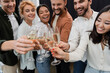 © LIGHTFIELD STUDIOS - Blurred multicultural business people toasting with champagne in office