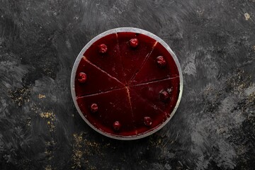 Top view of an appetizing cherry cheesecake decorated with cherries on top of it