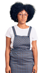 Poster - Young african american girl wearing casual clothes puffing cheeks with funny face. mouth inflated with air, crazy expression.