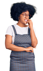 Sticker - Young african american girl wearing casual clothes looking stressed and nervous with hands on mouth biting nails. anxiety problem.