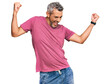 © Krakenimages.com - Middle age grey-haired man wearing casual clothes dancing happy and cheerful, smiling moving casual and confident listening to music