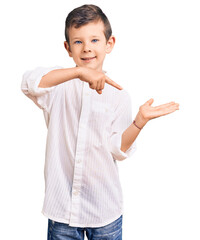 Poster - Cute blond kid wearing elegant shirt amazed and smiling to the camera while presenting with hand and pointing with finger.