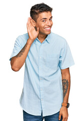 Sticker - Young handsome african american man wearing casual clothes smiling with hand over ear listening an hearing to rumor or gossip. deafness concept.