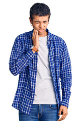 Poster - Young african amercian man wearing casual clothes touching mouth with hand with painful expression because of toothache or dental illness on teeth. dentist