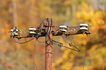 Old mast for power lines. Electrical wires are frayed.