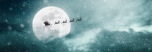 Santa Claus Flying On His Sleigh Over The Moon On Christmas Night
