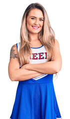 Sticker - Young beautiful blonde woman wearing cheerleader uniform happy face smiling with crossed arms looking at the camera. positive person.