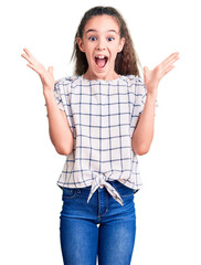 cute hispanic child girl wearing casual clothes celebrating crazy and amazed for success with arms r