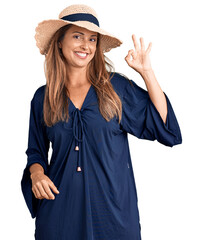 Canvas Print - Middle age hispanic woman wearing summer hat smiling positive doing ok sign with hand and fingers. successful expression.