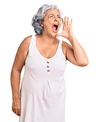 Sticker - Senior woman with gray hair wearing casual clothes shouting and screaming loud to side with hand on mouth. communication concept.