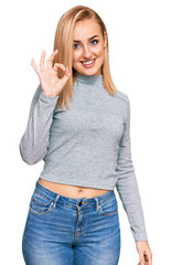 Wall Mural - Beautiful caucasian woman wearing casual clothes smiling positive doing ok sign with hand and fingers. successful expression.