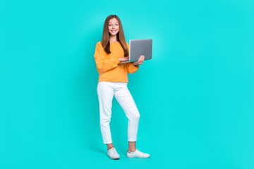 Poster - Full body size photo of cute excited teenager girl chatting online hold laptop remote education courses isolated on aquamarine color background