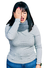 Wall Mural - Young hispanic plus size woman wearing winter scarf yawning tired covering half face, eye and mouth with hand. face hurts in pain.