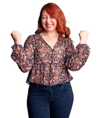 Sticker - Young beautiful redhead woman wearing casual t-shirt excited for success with arms raised and eyes closed celebrating victory smiling. winner concept.