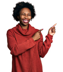 Wall Mural - African american woman with afro hair pointing with fingers to the side winking looking at the camera with sexy expression, cheerful and happy face.