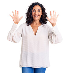 Wall Mural - Middle age beautiful woman wearing casual sweater showing and pointing up with fingers number ten while smiling confident and happy.