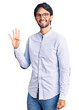 Handsome hispanic man wearing business shirt and glasses showing and pointing up with fingers number four while smiling confident and happy.