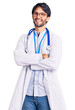 © Krakenimages.com - Handsome hispanic man wearing doctor uniform and stethoscope happy face smiling with crossed arms looking at the camera. positive person.