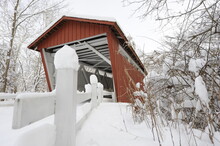 Red Covered Bridge In The Winter After A Snow Storm