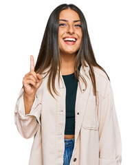 Wall Mural - Beautiful hispanic woman wearing casual clothes pointing finger up with successful idea. exited and happy. number one.