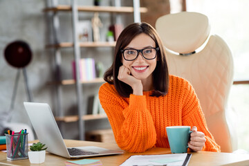 Poster - Portrait of positive pretty secretary sitting leather chair arm hold tea mug modern loft workplace indoors