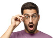© Damir Khabirov - Young man shouting oh my god with open mouth, holding round glasses, surprised by low price and sales