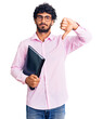 © Krakenimages.com - Handsome young man with curly hair and bear holding business folder with angry face, negative sign showing dislike with thumbs down, rejection concept