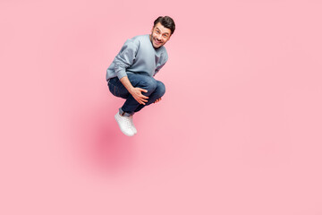 Sticker - Full size photo of handsome young man jumping high bomb swimming pool copyspace wear stylish blue outfit isolated on pink color background