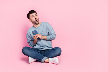 Poster - Full length photo of attractive young guy hold telephone terrified copyspace dressed trendy blue outfit isolated on pink color background