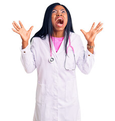 Canvas Print - Young african american woman wearing doctor stethoscope crazy and mad shouting and yelling with aggressive expression and arms raised. frustration concept.