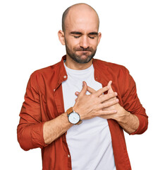 Canvas Print - Young hispanic man wearing casual clothes smiling with hands on chest with closed eyes and grateful gesture on face. health concept.