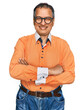 © Krakenimages.com - Middle age indian man wearing casual clothes and glasses happy face smiling with crossed arms looking at the camera. positive person.