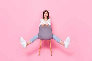 Poster - Full length photo of astonished pretty lady sit chair imagine can drive car adventure travel trendy wear isolated pink color background