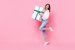 Full length photo of impressed cute lady hand hold carry huge box celebrate anniversary empty space isolated on pink color background