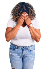 Wall Mural - Young african american plus size woman wearing casual clothes with sad expression covering face with hands while crying. depression concept.