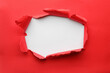 © New Africa - Hole in red paper on white background