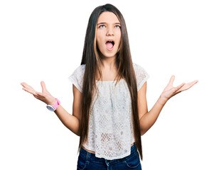 Sticker - Young brunette girl with long hair wearing white shirt crazy and mad shouting and yelling with aggressive expression and arms raised. frustration concept.