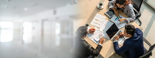 Business people group meeting shot from top widen view in office . Profession businesswomen, businessmen and office workers working in team conference with project planning document on meeting table .