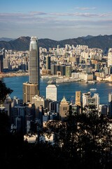 Poster - Scenic vertical view of the beautiful Victoria harbor in Hong Kong on a summer day