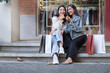© wattana - Two young beautiful hipster women sitting on urban city staircase after finished shopping.