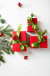 © Olha Afanasieva - Red Christmas present box with green bow and fir branches top view
