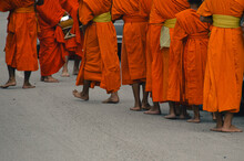Buddhist Monks During Sai Bat Or Tak Bat, The Traditional Morning Alms Giving Ceremony In Luang Prabang, Laos