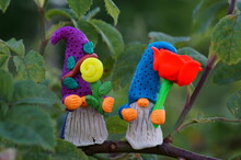 Figures Of Dwarfs With Flowers On A Tree Branch. Fabulous Toys Made Of Plasticine.