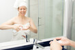 © yta - washing face, woman in bathtub with facial foam