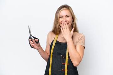 Wall Mural - Young blonde seamstress woman isolated on white background happy and smiling covering mouth with hand