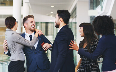 Business people, hug and friends in social fun together for business success, communication or team building at the office. Group of happy employee workers enjoying team conversation at the workplace