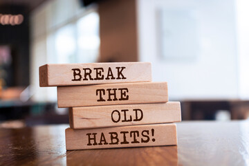 Wooden blocks with words 'Break the old habits'.